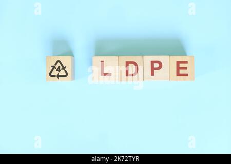Recycling icon number 4 for LDPE or Low Density Polyethylene symbol on wooden blocks flat lay. Stock Photo