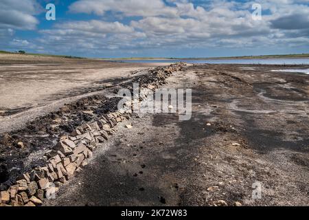 The remains of an old Cornish Hedge wall exposed by falling water levels caused by severe drought conditions at Colliford Lake Reservoir on Bodmin Moo Stock Photo