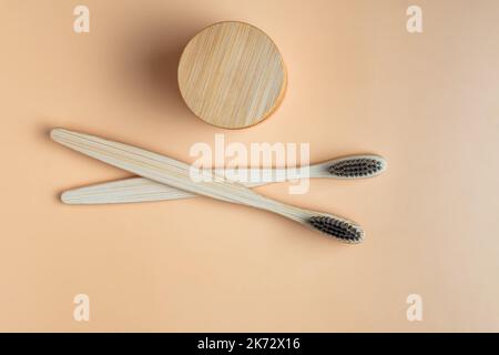 Eco-friendly bamboo toothbrushes and dentifrice on beige background. Natural organic bathroom beauty product concept. Flat lay, top view, copy space Stock Photo