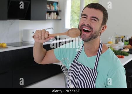Man singing in the kitchen Stock Photo