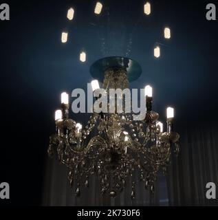 Vintage style chandelier with light reflection on the ceiling Stock Photo