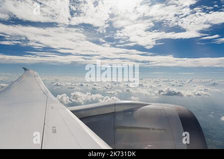 Flying and traveling, view from an airborn airplane window on the wing Stock Photo