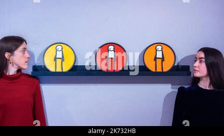 London, UK.  17 October 2022. Staff members view ‘Plaque (Red), Plaque (Orange), Plaque (Yellow)’, 2011, by Stik (Est. £35,000 - £55,000) at the preview of Pop X Culture, a sale at Bonhams, New Bond Street, celebrating pop culture.  The 146-lots feature contemporary art, prints and multiples, film and music memorabilia, and fashion and the way artists have responded to the entertainment industry’s output.  The sale takes place on 20 October.  Credit: Stephen Chung / Alamy Live News