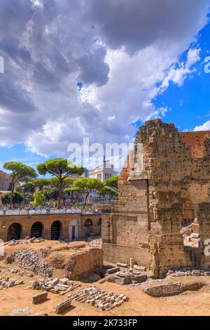 Rome cityscape: the ruins of the Forum of Nerva  (Forum Transitorium) and the Via dei Fori Imperiali, in the background the Altar of Peace. Stock Photo