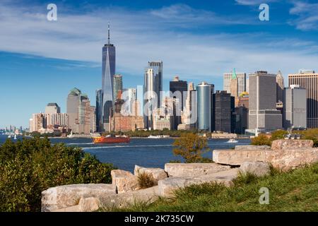 New York City skyline from Governor's Island. View of World Trade Center in Lower Manhattan (Financial District) and ferry boat Stock Photo