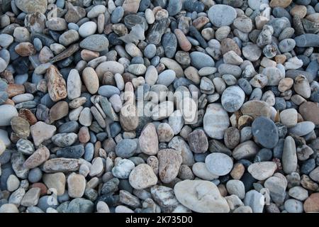 photo a lot of multicolored stones on the beach Stock Photo