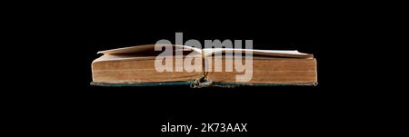 an old open book isolated on a black background close up with clipping path Stock Photo