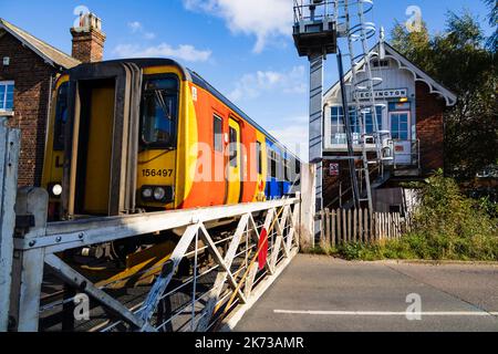 East Midlands Trains, Class 156, 156497, at the level crossing, Station, signal box and manual level crossing. Heckington village, Lincolnshire, Engla Stock Photo