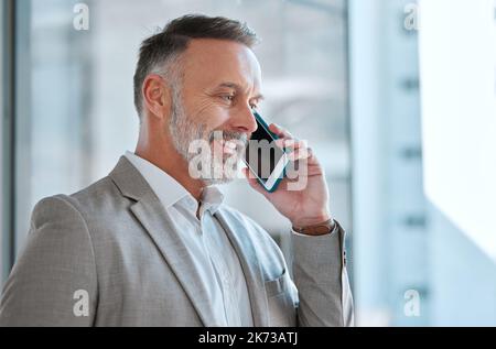 Wealth consists not in having great possessions. a businessman on a call at work in a office. Stock Photo