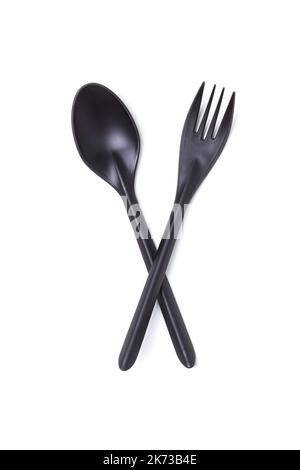 Black plastic disposable crossed spoon and fork isolated on white Stock Photo