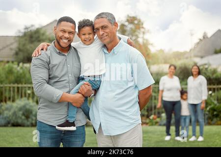 I have a wonderful shelter, which is my family. a father and grandpa holding a little boy in the yard. Stock Photo