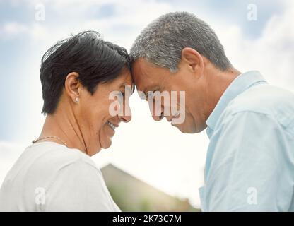 Love lives here. a senior couple staring at each other outside. Stock Photo