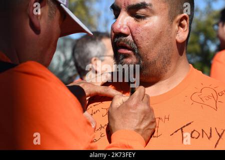 Montreal Canada (September 30, 2022): Protesters pay respect by signing 'Orange Day Shirt' of Indigenous man during the “Canada’s National Day for Truth & Reconciliation” that highlights the plight of the Indian Residential School childrens survivors. Stock Photo