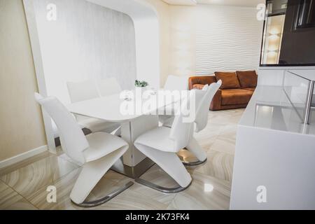 View of luxury expensive modern fitted kitchen with stainless steel appliances. Design of the kitchen room. Stock Photo