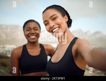 My friends are my life. two friends taking selfies during a workout. Stock Photo