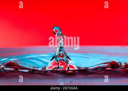 Colorful water drop splash on the surface. Stock Photo