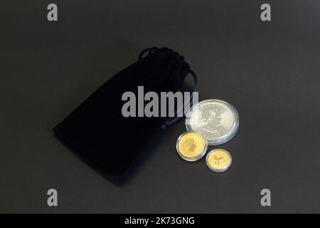 Helsingi, Finland - August 16, 2018: Bullion Investment gold coins in black velvet gift bag on dark background. Stock Photo