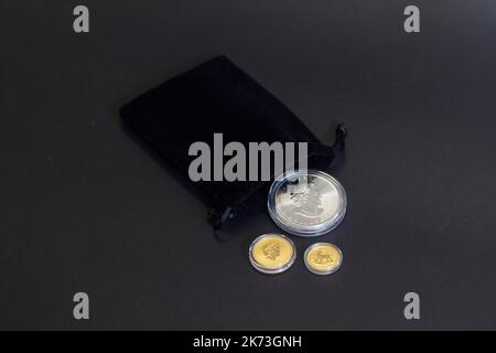 Helsingi, Finland - August 16, 2018: Bullion Investment gold coins in black velvet gift bag on dark background. Stock Photo