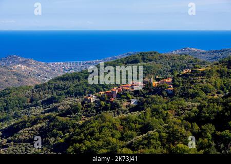 A breathtaking view of the Ligurian mountains and the Mediterranean coast. In the foreground a view of the village of Valloria. Valloria is one of the Stock Photo