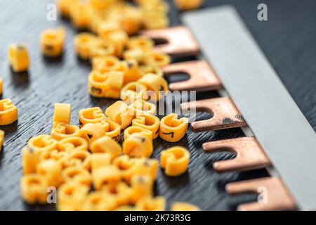 Cable markers scattered on the table, macro shot. Stock Photo