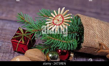 Jute bag with spruce branch and Christmas decoration Stock Photo