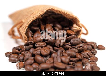 Roasted coffee beans in a jute sack Stock Photo