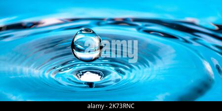 Blue water drop splash on the surface. Stock Photo