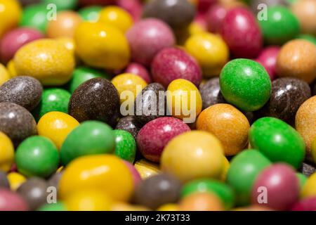 Peanuts covered with multicolored glaze, close up. Stock Photo