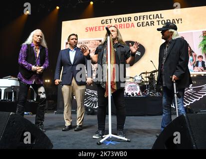 Hollywood FL, USA. 16th Oct, 2022. Florida Governor Ron DeSantis, Johnny Van Zant and Rickey Medlocke are seen on stage during a check presentation for Hurricane Ian relief before Lynyrd Skynyrd perform at Hard Rock Live held at the Seminole Hard Rock Hotel & Casino on October 16, 2022 in Hollywood, Florida. Credit: Mpi04/Media Punch/Alamy Live News Stock Photo