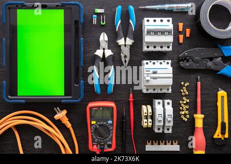 Different electrical tools on wooden background, flat lay. Stock Photo