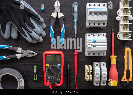 Different electrical tools on wooden background, flat lay. Stock Photo