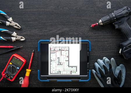 Composition with digital tablet and electrician work items. Stock Photo