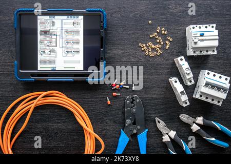Different electrical tools and digital tablet on wooden background, flat lay. Stock Photo
