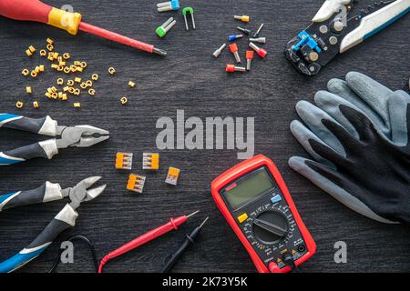 Different electrical tools on wooden background, flat lay. Stock Photo