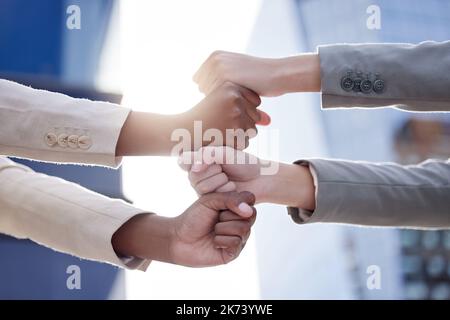 Were in business. two unrecognizable businesspeople stacking their fists outside. Stock Photo