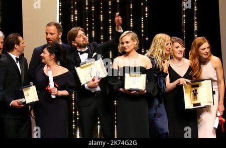 Swedish director Ruben Ostlund (L) poses on stage with his trophy after he won the Palme d'Or for his film 'The Square' on May 28, 2017 during the closing ceremony of the 70th edition of the Cannes Film Festival in Cannes, southern France.   70th annual Cannes Film Festival in Cannes, France, May 2017. The film festival will run from 17 to 28 May. Stock Photo