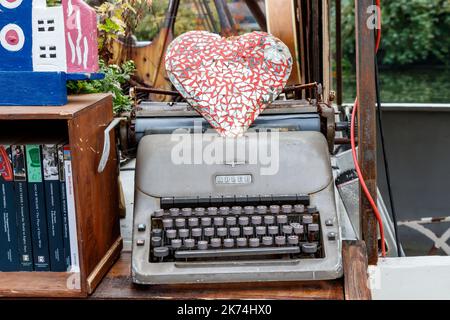 An old Adler typewriter on Word On The Water, aka The London Bookbarge, a floating bookshop on Regents Canal at King's Cross, London, UK Stock Photo