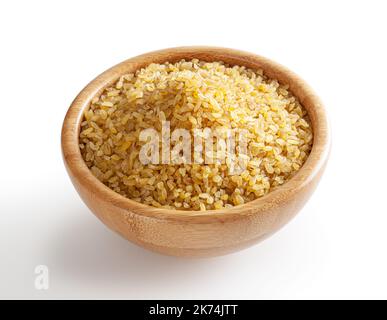 Uncooked bulgur in wooden bowl isolated on white background with clipping path Stock Photo