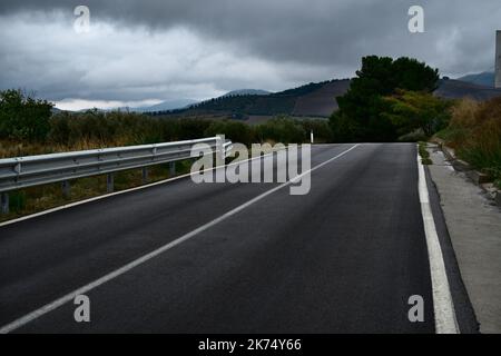 straight road and bad weather in Sicily, Italy Stock Photo