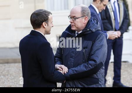 French President Emmanuel Macron welcomes Prince Albert II of Monaco as he arrives at the Elysee palace in Paris, for a lunch hosted by the French President as part of the One Planet Summit.  Macron is hosting the One Planet climat summit, which gathers world leaders, philantropists and other committed private individuals to discuss climate change. 12.12.2017 Stock Photo