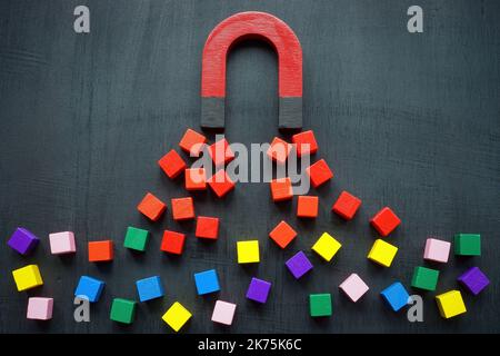 The magnet attracts colored cubes. Leads generation and acquisition concept. Stock Photo