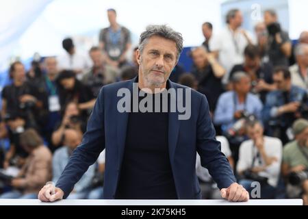 Polish director Pawel Pawlikowski waves on May 11, 2018 during a photocall for the film 'Cold War (Zimna Wojna)' at the 71st edition of the Cannes Film Festival in Cannes, southern France. Stock Photo