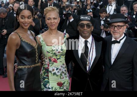 US director Spike Lee (2ndR) and his wife US producer Tonya Lewis Lee (2ndL) and US actress Laura Harrier (L) pose as they arrive on May 19, 2018 for the closing ceremony and the screening of the film 'The Man Who Killed Don Quixote' at the 71st edition of the Cannes Film Festival in Cannes, southern France. Stock Photo