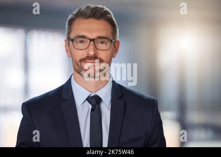 Confident in my abilities. Portrait of a mature businessman standing in a modern office at work. Stock Photo