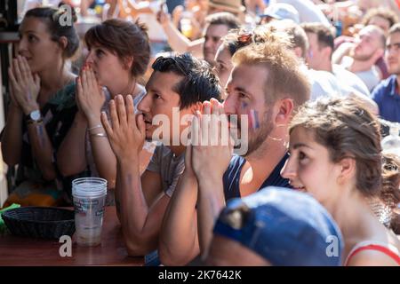 Christophe Morin / IP3 . French supporters look in a bar, the final of the 2018 Football World Cup between France and Croatia, in Paris, France, on July 15th, 2018. Stock Photo