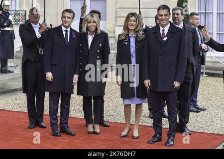 French President Emmanuel Macron (L) and his wife Brigitte Macron (2-L) welcome Spain's Prime Minister Pedro Sanchez (2-R) and his wife Maria Begona Gomez Fernandez (3-R) at the Elysee Palace ahead of the international ceremony for the Centenary of the WWI Armistice of 11 November 1918, in Paris, Franc Stock Photo