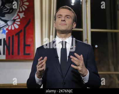 French President Emmanuel Macron, gestures as he poses for a photograph after the recording of his New Year's speech at at the Elysee Palace, in Paris, Monday, Dec. 31, 2018.   Stock Photo