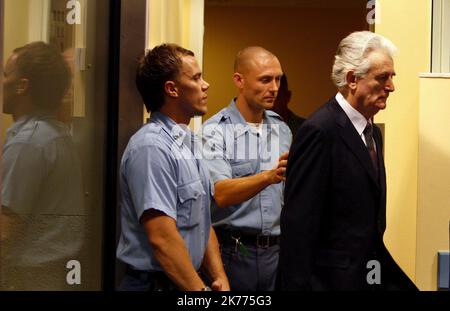 Former Bosnian Serb leader Radovan Karadzic (R) enters the court room of the International Criminal Tribunal for the Former Yugoslavia at the start of his initial appearance in The Hague, Netherlands on 31 July 2008. Karadzic faces a UN war crimes judge for the first time to answer charges of genocide for his actions in the 1992-95 Bosnia war. Stock Photo