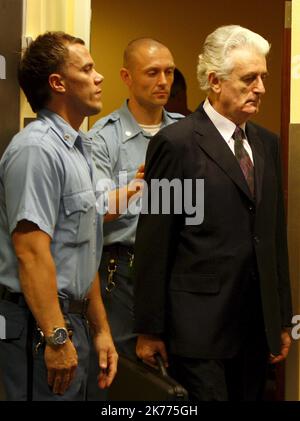 Former Bosnian Serb leader Radovan Karadzic (R) enters the court room of the International Criminal Tribunal for the Former Yugoslavia at the start of his initial appearance in The Hague, Netherlands on 31 July 2008. Karadzic faces a UN war crimes judge for the first time to answer charges of genocide for his actions in the 1992-95 Bosnia war. Stock Photo
