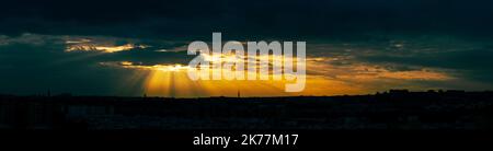 Panorama of a dramatic stormy sunset over the city. Fantastic skies on the planet earth. Stock Photo